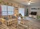 Bright living room with cozy seating, a decorative tree, and a sliding glass door at 1058 Sea Mountain Hwy. # 14-203, North Myrtle Beach, SC 29582