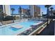 Expansive outdoor pool area surrounded by palm trees, and multiple lounge chairs for relaxation at 1600 Ocean Blvd. S # 226, Myrtle Beach, SC 29577