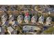 Aerial community view including a pool, a home with an arrow above it, and lush landscaping at 1604 Cottage Cove Circle, North Myrtle Beach, SC 29582
