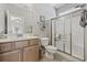 Bright bathroom with a glass door shower, wood vanity and ample counter space providing a functional space at 1604 Cottage Cove Circle, North Myrtle Beach, SC 29582