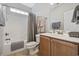 Well-lit bathroom featuring a tub-shower combo and a wood-trimmed vanity at 1604 Cottage Cove Circle, North Myrtle Beach, SC 29582