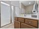Bright bathroom featuring a glass-enclosed shower, a wooden vanity with sink, and a well-lit mirror at 1604 Cottage Cove Circle, North Myrtle Beach, SC 29582
