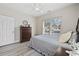 Well-lit bedroom featuring a bed, dresser, and a window with neighborhood views at 1604 Cottage Cove Circle, North Myrtle Beach, SC 29582