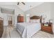 Comfortable bedroom featuring wood floors, a cozy bed, and an open doorway to a full, private bathroom at 1604 Cottage Cove Circle, North Myrtle Beach, SC 29582