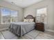 Cozy bedroom with a queen-sized bed, bedside table, and natural light from two windows at 1604 Cottage Cove Circle, North Myrtle Beach, SC 29582