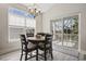 Dining area featuring a round wooden table, four chairs, and sliding glass doors to the outdoor patio at 1604 Cottage Cove Circle, North Myrtle Beach, SC 29582