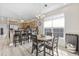 Dining area connected to kitchen with a round wooden table and bright window light at 1604 Cottage Cove Circle, North Myrtle Beach, SC 29582