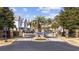 Community entrance with palm trees and a decorative sign with brick columns at 1604 Cottage Cove Circle, North Myrtle Beach, SC 29582