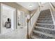 Inviting entryway with stairs leading to the upper level, showcasing views of the living room and bedroom at 1604 Cottage Cove Circle, North Myrtle Beach, SC 29582