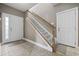 Welcoming entryway with a tiled floor, showcasing a staircase with carpeted steps and white-painted doors at 1604 Cottage Cove Circle, North Myrtle Beach, SC 29582