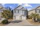 Charming two-story home featuring a double garage, light-blue siding, and mature palm trees in the front yard at 1604 Cottage Cove Circle, North Myrtle Beach, SC 29582