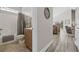 Hallway leading to a bathroom and living area, showcasing the flooring and decor at 1604 Cottage Cove Circle, North Myrtle Beach, SC 29582