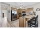 A stylish kitchen featuring stainless steel appliances, wood cabinets, granite countertops, and bar seating at 1604 Cottage Cove Circle, North Myrtle Beach, SC 29582