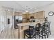 A stylish kitchen featuring stainless steel appliances, wood cabinets, granite countertops, and bar seating at 1604 Cottage Cove Circle, North Myrtle Beach, SC 29582