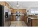 Kitchen featuring stainless steel appliances, wood cabinets, tile backsplash, and a breakfast bar at 1604 Cottage Cove Circle, North Myrtle Beach, SC 29582