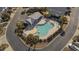 Overhead view of a community pool featuring a pool house, lounge chairs, and manicured landscaping at 1604 Cottage Cove Circle, North Myrtle Beach, SC 29582