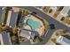 Aerial view of community pool featuring lounge chairs, landscaping and a pool house at 1604 Cottage Cove Circle, North Myrtle Beach, SC 29582