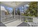 View from a screened-in porch overlooking backyard, featuring white railings and ceiling fan at 1604 Cottage Cove Circle, North Myrtle Beach, SC 29582