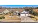 Aerial view of a traditional home with a manicured lawn, garden, and a three car garage at 1606 Lake Egret Dr., North Myrtle Beach, SC 29582