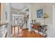 Welcoming foyer with hardwood floors, elegant lighting, stairs to upper level, and decorative console table at 1606 Lake Egret Dr., North Myrtle Beach, SC 29582