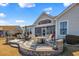 This patio features an outdoor fire pit, seating, a grill, and an umbrella covered table at 1606 Lake Egret Dr., North Myrtle Beach, SC 29582