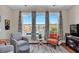 Cozy sitting area with large windows, comfortable chairs, and views of the lake and neighboring homes at 1606 Lake Egret Dr., North Myrtle Beach, SC 29582