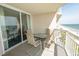 Balcony with seating overlooking the ocean and sandy beach with chairs and umbrellas at 1625 S Ocean Blvd. # 1109, North Myrtle Beach, SC 29582