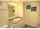 Well-lit bathroom showcasing a granite countertop, sink, mirror, and fish-themed artwork on the wall at 1625 S Ocean Blvd. # 1109, North Myrtle Beach, SC 29582