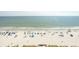 Beautiful view of the beach with white sand, blue umbrellas, and the expansive ocean at 1625 S Ocean Blvd. # 1109, North Myrtle Beach, SC 29582