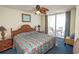 This vibrant bedroom offers a ceiling fan and access to the balcony at 1625 S Ocean Blvd. # 1109, North Myrtle Beach, SC 29582