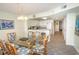 Dining area with a glass table and kitchen view with tiled floors and nautical decor at 1625 S Ocean Blvd. # 1109, North Myrtle Beach, SC 29582