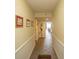 Hallway with tiled floors and white trim leads to a common area with beach view at 1625 S Ocean Blvd. # 1109, North Myrtle Beach, SC 29582