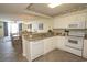 Bright kitchen with white appliances, tiled floors, granite countertops, and adjacent dining area at 1625 S Ocean Blvd. # 1109, North Myrtle Beach, SC 29582