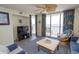 Bright living room with tropical decor, ocean view balcony, and comfortable seating at 1625 S Ocean Blvd. # 1109, North Myrtle Beach, SC 29582
