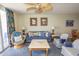 Inviting living room featuring comfortable seating, ceiling fan, and bright natural light at 1625 S Ocean Blvd. # 1109, North Myrtle Beach, SC 29582