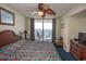 Cozy bedroom with a palm leaf ceiling fan and a balcony overlooking the ocean view at 1625 S Ocean Blvd. # 1109, North Myrtle Beach, SC 29582
