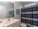 Bathroom featuring a vanity, commode, sink, framed art, and a shower with a blue striped curtain at 206 Marley Ct., Conway, SC 29526