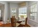 Bright breakfast nook with a glass table, wooden chairs and natural light flooding through the windows at 206 Marley Ct., Conway, SC 29526