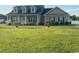 Charming single-story home with a manicured lawn, complemented by palm trees and gray siding at 206 Marley Ct., Conway, SC 29526