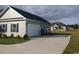 Attached two-car garage with adjacent parking area, complementing the home's exterior at 206 Marley Ct., Conway, SC 29526