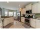 Well-lit kitchen with stainless steel appliances and granite countertops offers a modern aesthetic at 206 Marley Ct., Conway, SC 29526