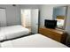Comfortable beds and furnishings in the bedroom, including a dresser with TV and a mirror at 2201 S Ocean Blvd. # 1603, Myrtle Beach, SC 29577