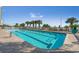 Resort-style outdoor pool, perfect for swimming laps or lounging, with palm trees and clear blue skies at 2201 S Ocean Blvd. # 1603, Myrtle Beach, SC 29577