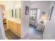 Bright bathroom featuring a light wood vanity and a doorway that leads to the bedroom at 2203 Sweetwater Blvd. # 2203, Murrells Inlet, SC 29576