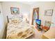 Cozy bedroom with floral bedding, complementing wall art, and a window offering natural light at 2203 Sweetwater Blvd. # 2203, Murrells Inlet, SC 29576