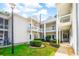 Well-maintained condo with green lawn, lush landscaping, and a charming white exterior at 2203 Sweetwater Blvd. # 2203, Murrells Inlet, SC 29576