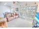 A living room with plush seating, a ceiling fan, and sliding glass doors for ample natural light at 2203 Sweetwater Blvd. # 2203, Murrells Inlet, SC 29576