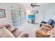 Living room with plush seating and sliding glass doors allowing ample natural light to flood the space at 2203 Sweetwater Blvd. # 2203, Murrells Inlet, SC 29576