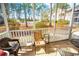 Patio features a screened-in porch area with outdoor seating, surrounded by lush greenery at 2203 Sweetwater Blvd. # 2203, Murrells Inlet, SC 29576