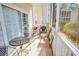 A screened-in patio with comfortable seating, perfect for outdoor relaxation and entertaining guests at 2203 Sweetwater Blvd. # 2203, Murrells Inlet, SC 29576